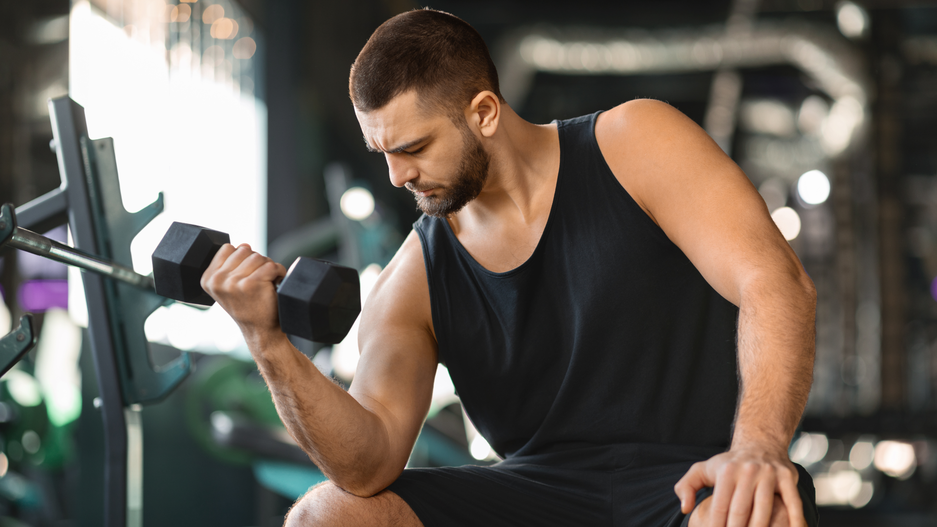 Man doing seated dumbbell curls